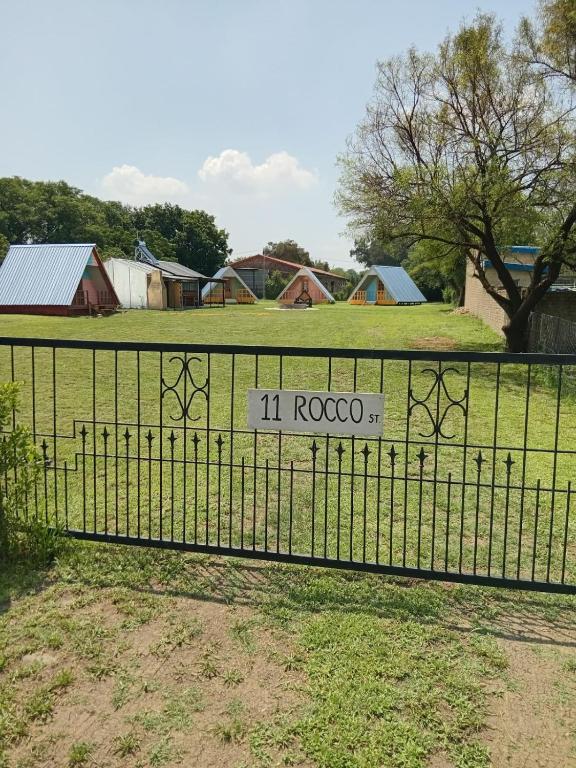 a sign on a fence in a field at Dam Jam Cabanas in Oranjeville