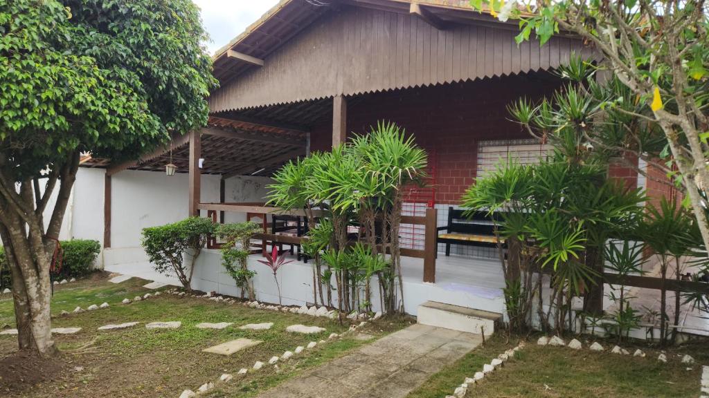 a house with a fence and trees in front of it at GRA325 | Spacious Retreat with Pool and Barbecue. in Gravatá