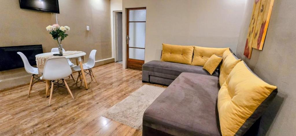 a living room with a couch and a table at APART ALVARADO microcentro in Salta