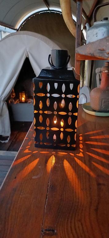 a black box sitting on a wooden table with a tent at Groot Gryses Adam Se Uitspanning in Orania