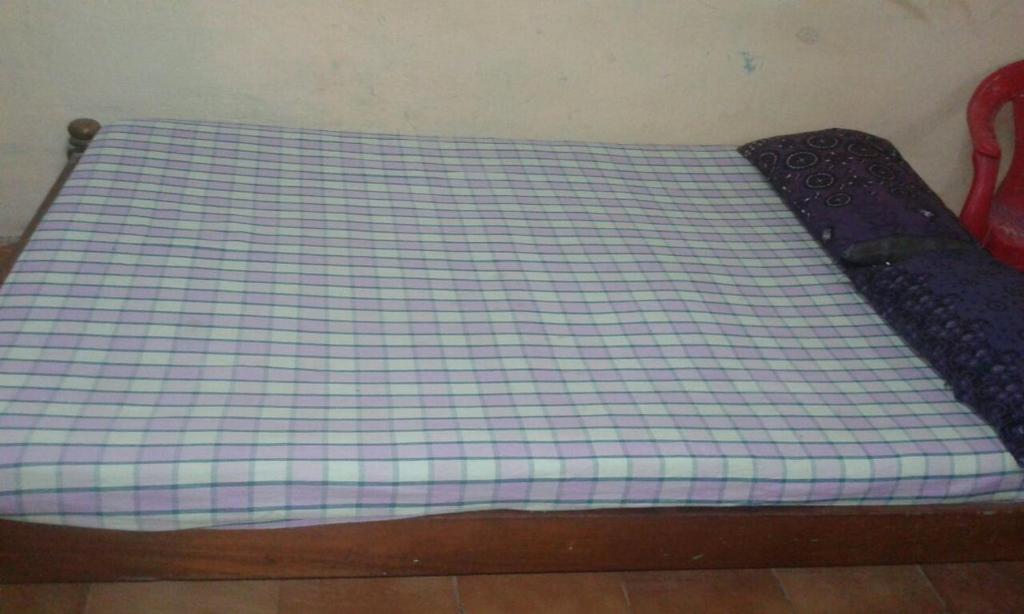 A bed or beds in a room at Xavier Guest House