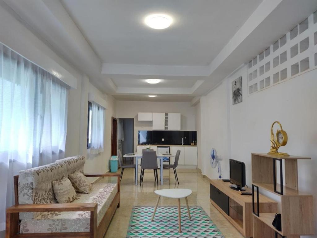 a living room with a couch and a table at Résidence DELIA in Diego Suarez