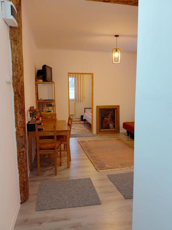 a living room with a table and a dining room at Happy Place Apartment in Lupeni