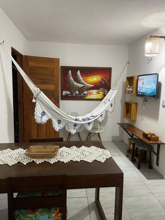 a living room with a hammock in a room at Casa De Vó in Amontada