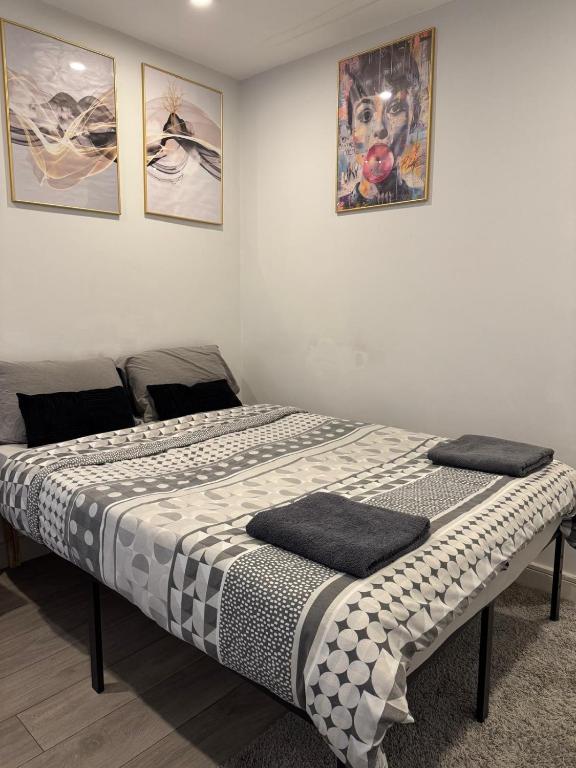 a bed in a room with two pillows on it at Brigstock3 in Thornton Heath