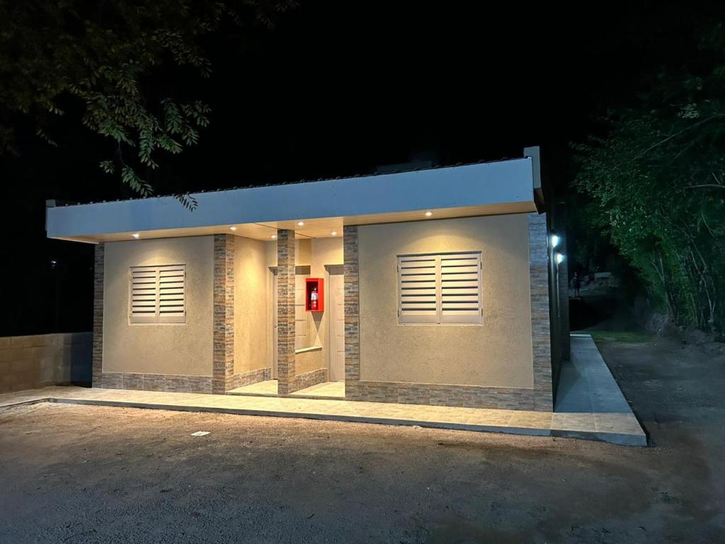 a small building with two garage doors at night at El Atardecer in Trapiche