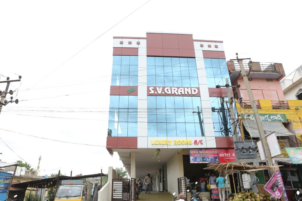 a building with a sign on the side of it at SV Grand in Proddatūr