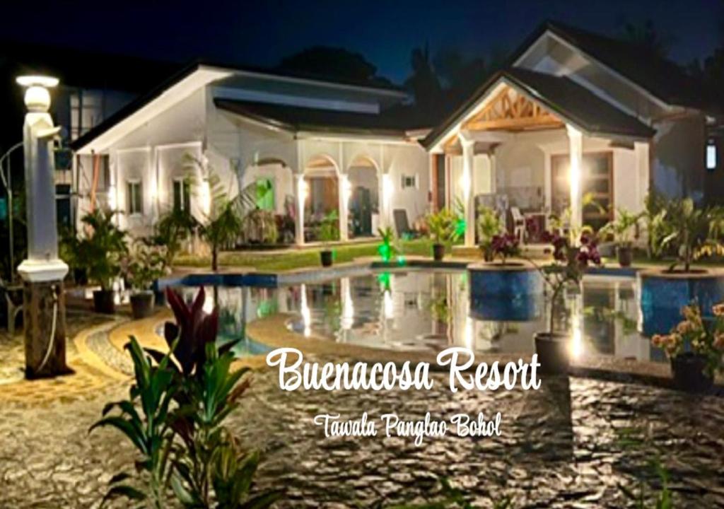 a house with a swimming pool in front of it at Buenacosa Resort in Panglao Island
