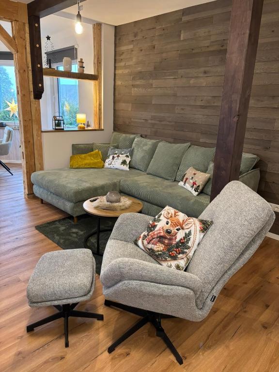 a living room with a couch and a chair at Stadtblick Ferienwohnung in Braunlage