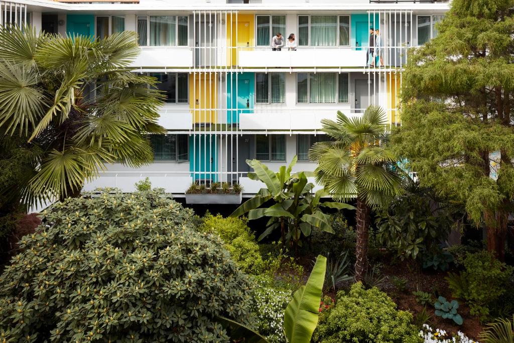 a building with colorful windows and palm trees at The Burrard in Vancouver