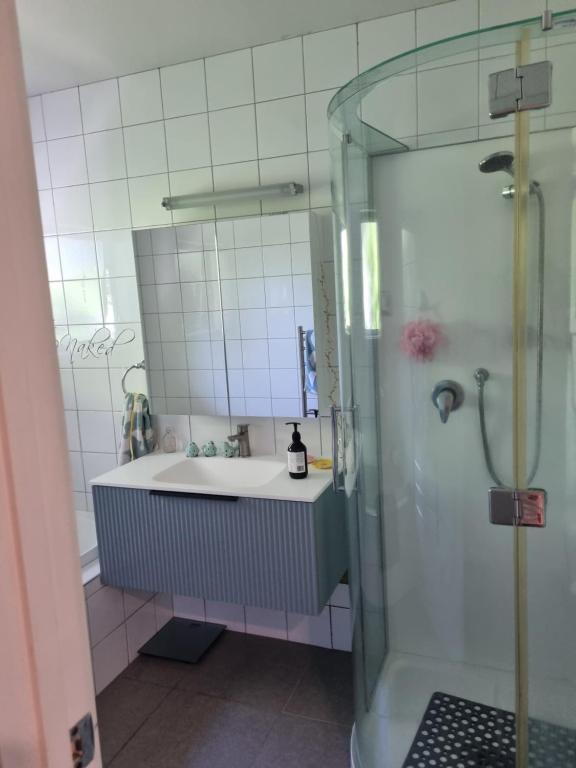 a bathroom with a sink and a shower at Norfolk House in Gisborne