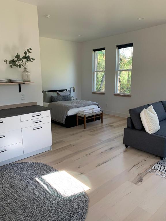 a living room with a bed and a couch at Sautee Nacoochee Studio near Helen in Sautee Nacoochee