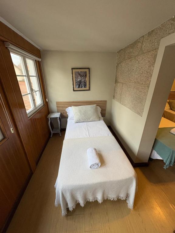 a small room with two beds in it at Hotel Real in Santiago de Compostela