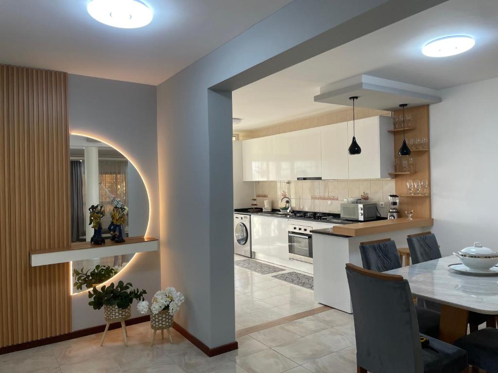 a kitchen and dining room with a dining table at Hendy's cozy apt in Praia
