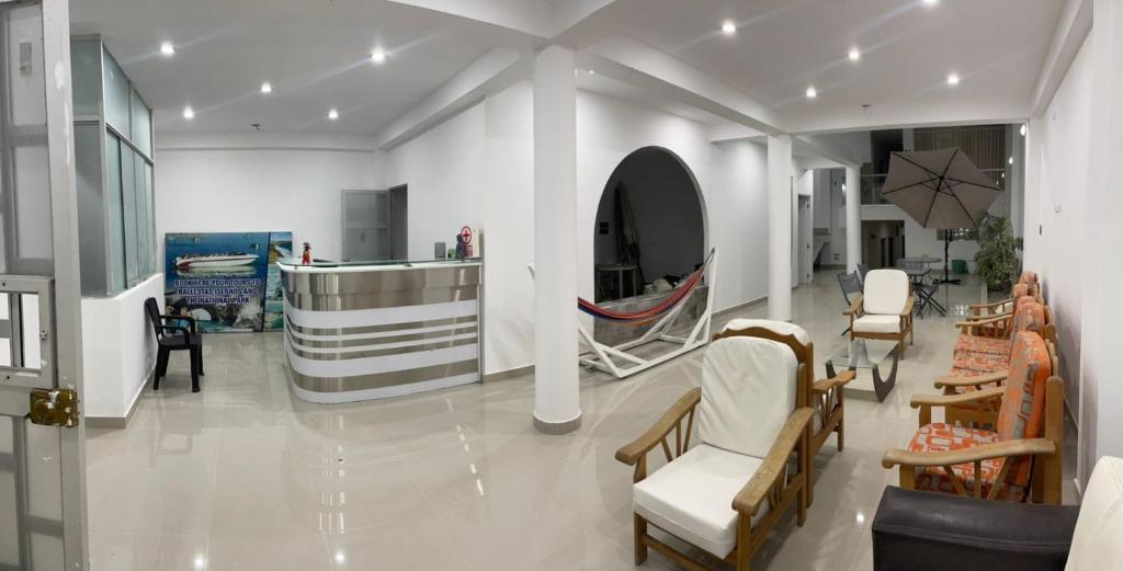a living room with chairs and furniture in a room at Antares Paracas in Paracas