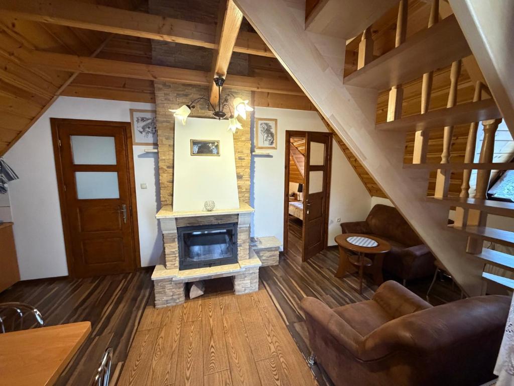 a living room with a fireplace in a house at Noclegi u Gubały in Szaflary