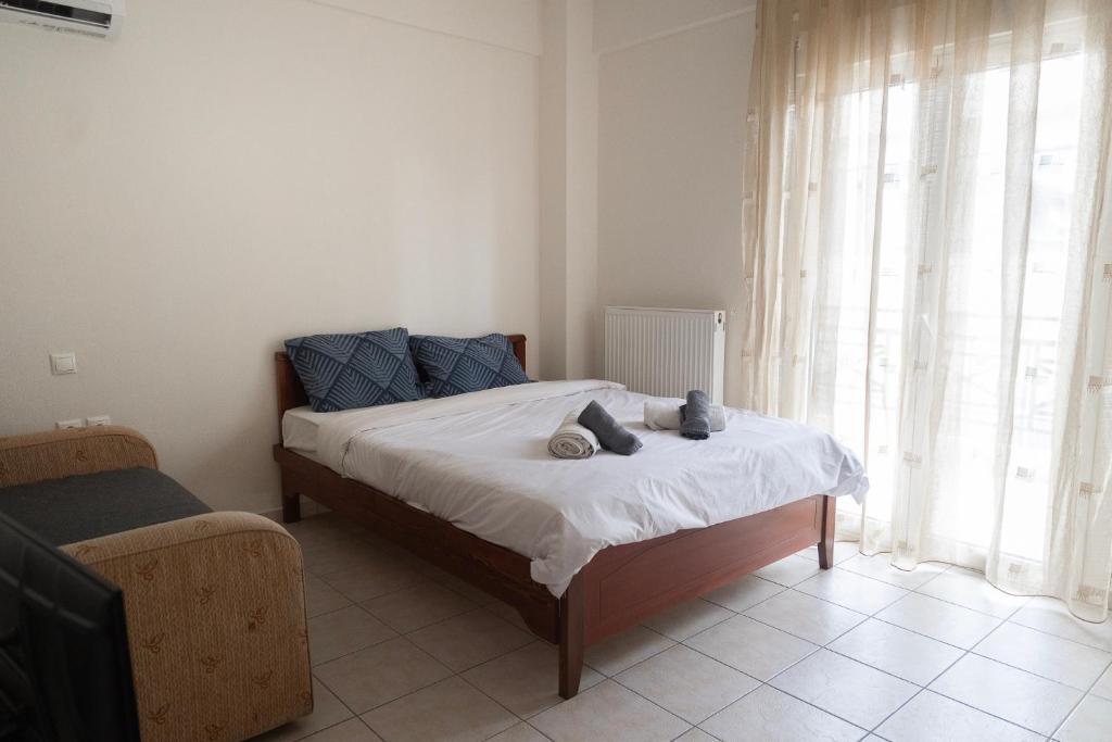 a bedroom with a bed with two stuffed animals on it at Philoxenia Studio Larissa in Larisa