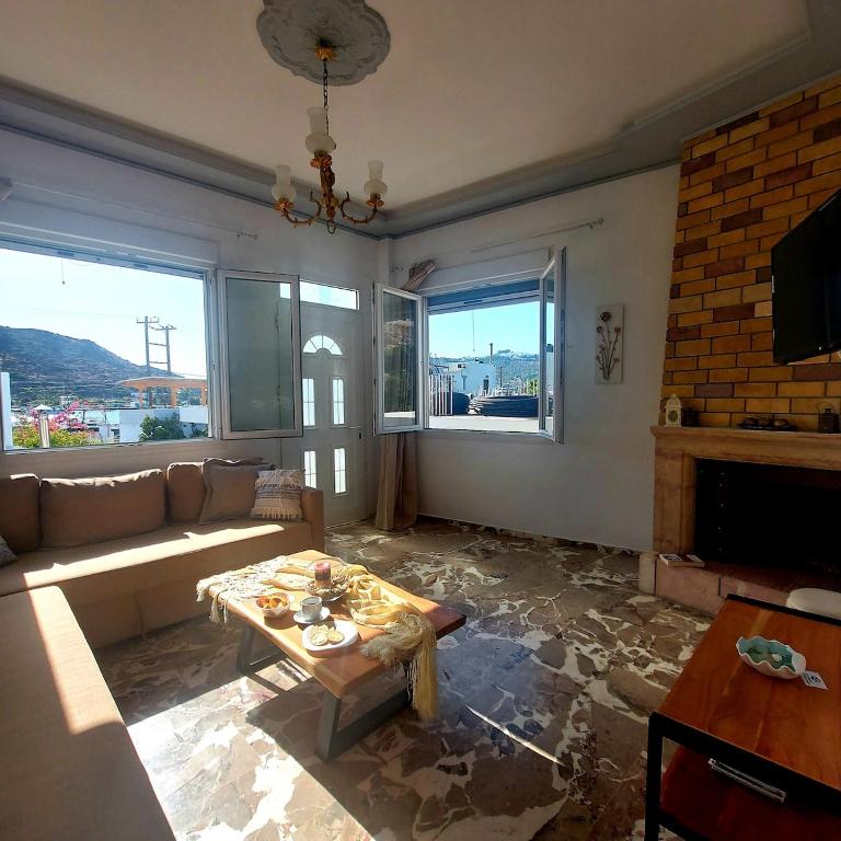 a living room with a couch and a table at Calliope #1 in Skala