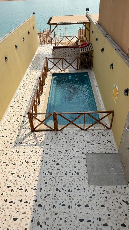 a swimming pool on the side of a building at درة العروس اكواخ الدره in Durat Alarous