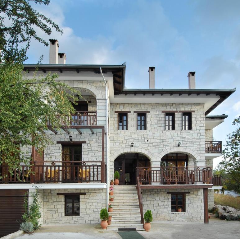 a large white brick house with a balcony at Mikri Arktos in Elati