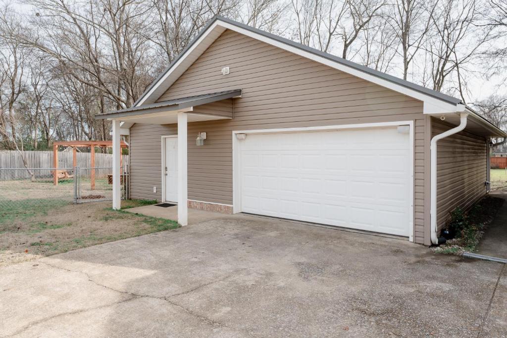 a garage with a white garage door at The Alabama Guest House in Tuscaloosa