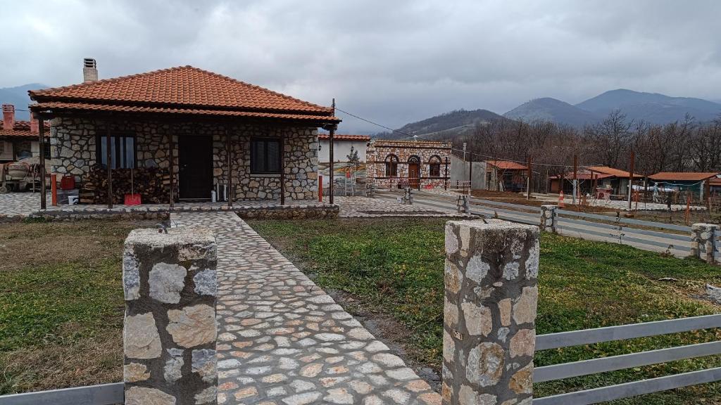 a small building with a fence in front of it at Leo Villas in Florina