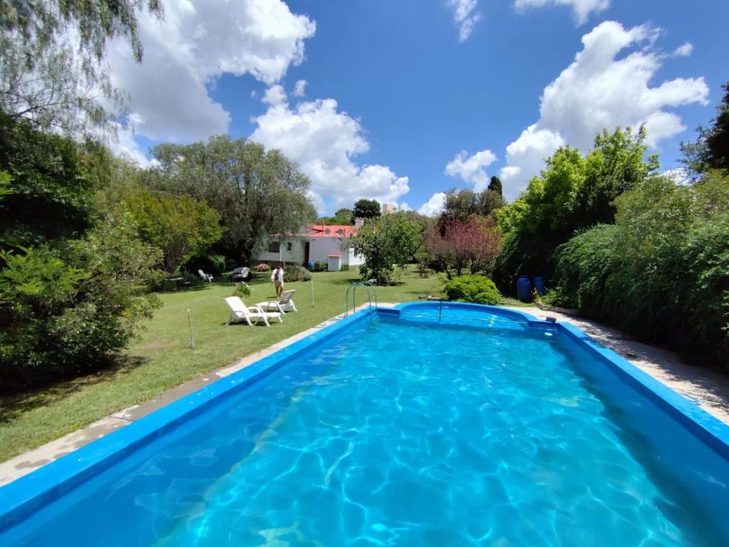 a swimming pool in the backyard of a house at Munay Posada in Los Cocos