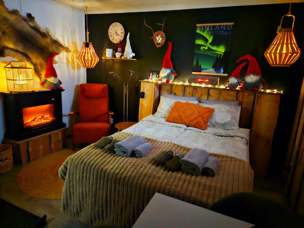 a bedroom with a bed with santa hats on it at Nordic Nest Living. in Rovaniemi