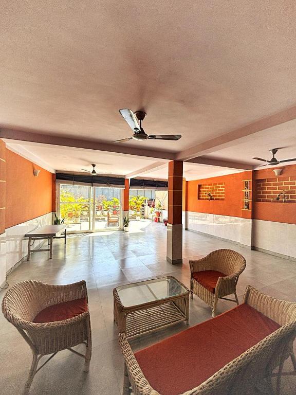 a living room with chairs and a table at Ashu Villa in New Delhi