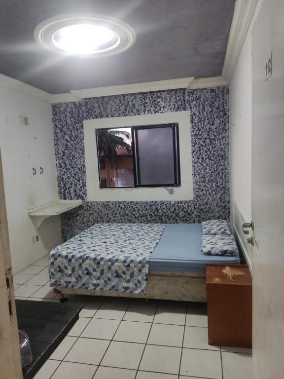 a bedroom with a bed and a tv on a wall at Hotel Panorama do Mar - Praia do Futuro in Fortaleza