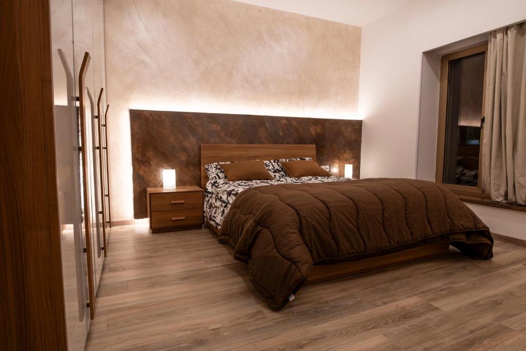 a bedroom with a large bed and a window at Al Melograno in Aquilinia