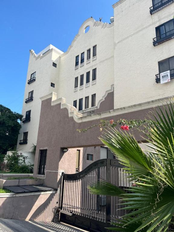 a large white building with a gate in front of it at Cerca de todo en San Jerónimo in Monterrey