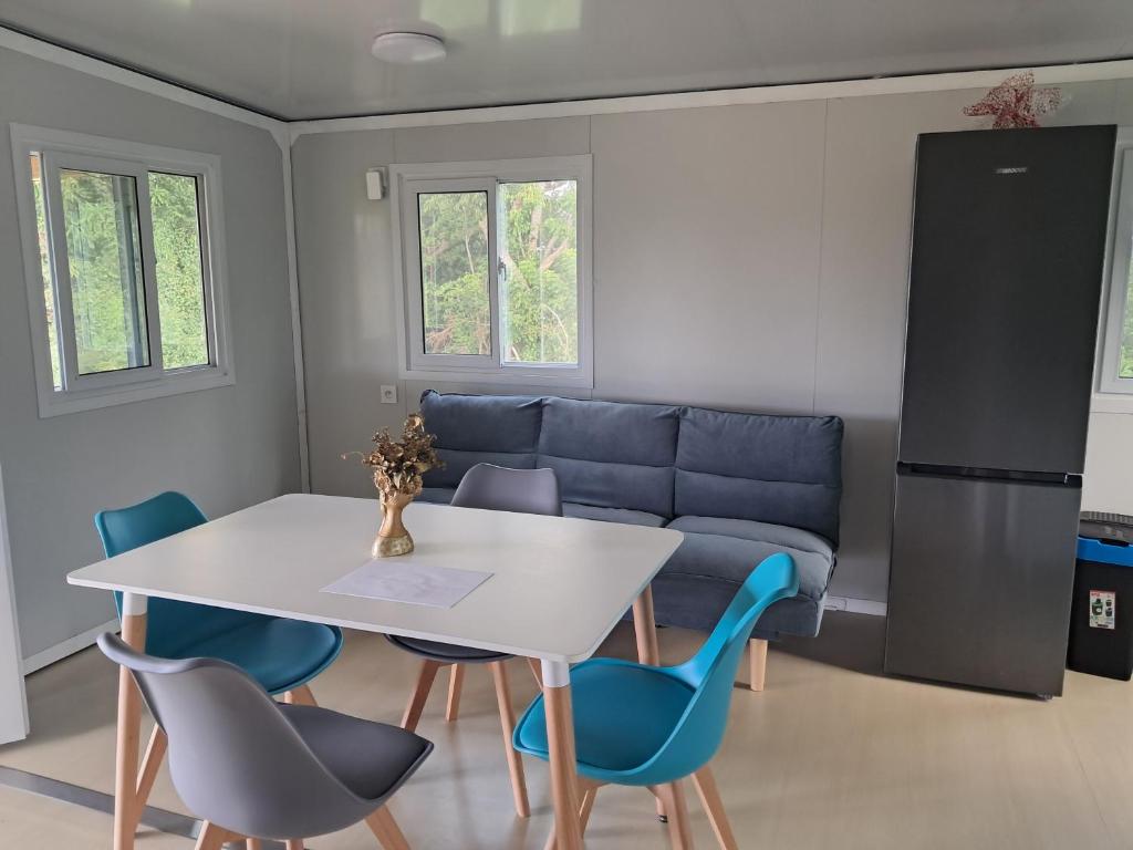 a living room with a table and chairs and a couch at Villa Océanne in Grand-Bourg
