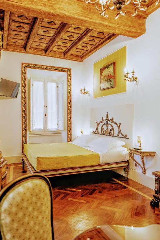 a bedroom with a large bed and a window at Arpinelli Suite in Rome