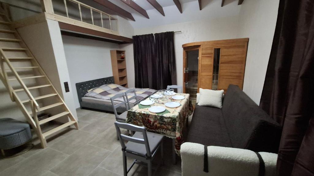 a living room with a table and bunk beds at Edelweiss Vila Šventoji in Šventoji