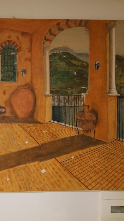 een schilderij van een kamer met een tafel en een stoel bij Villino Angela A Sant'Anna in Boscotrecase