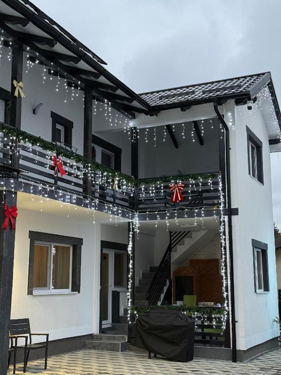 a house with christmas lights on the front of it at Casa IL LUCE in Câmpulung Moldovenesc
