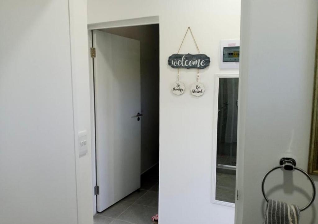two pictures of a bathroom with an open door at Bee Bee Adventures in Ballito