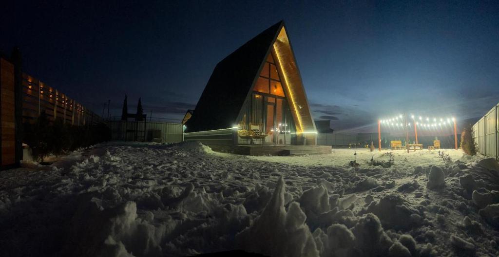 a large building in the snow at night at Day Off in Dushetʼi