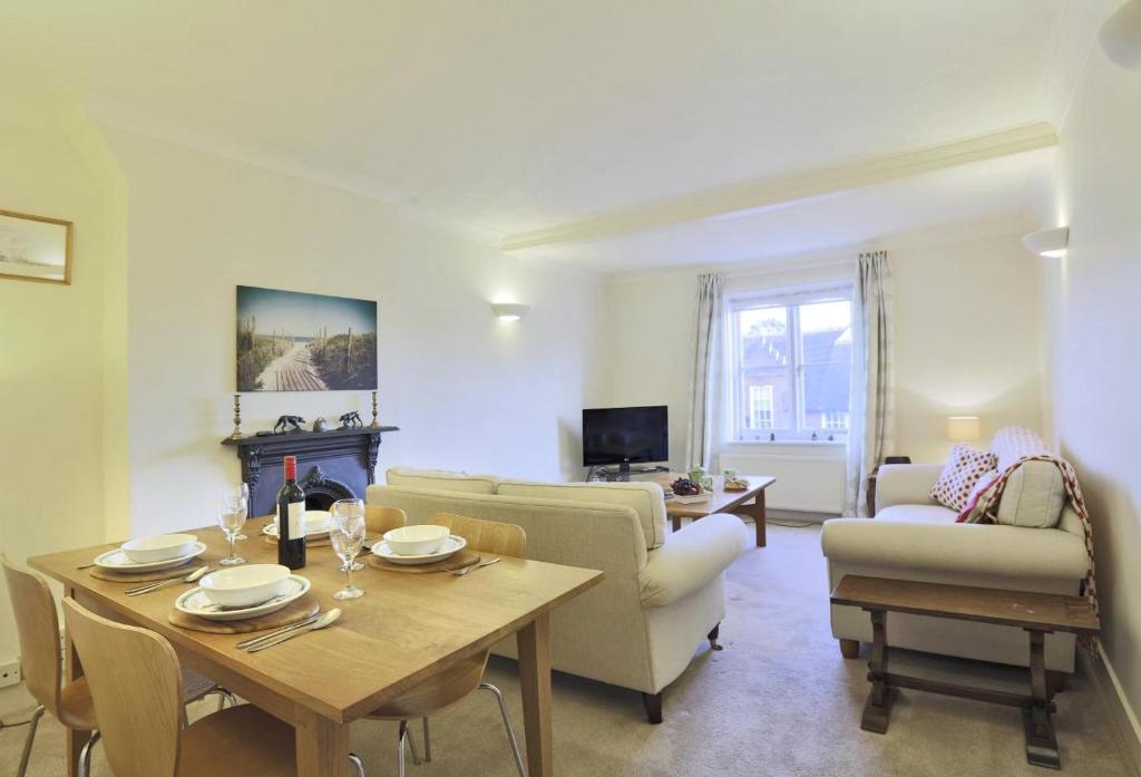 a living room with a table and a couch at 3 Bed in Woodbridge oc-tst in Melton