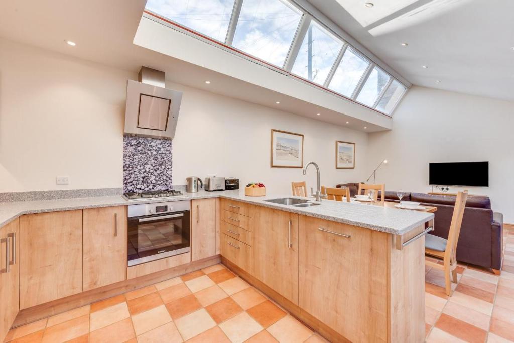 a kitchen with a skylight and a living room at 2 Bed in Southwold oc-weh in Southwold