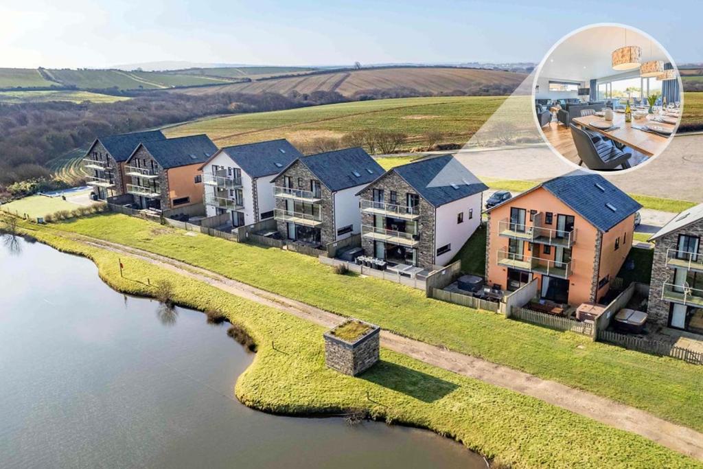 an aerial view of a house with a body of water at 6 Bed in Winnards Perch oc-t29966 in Saint Columb Major