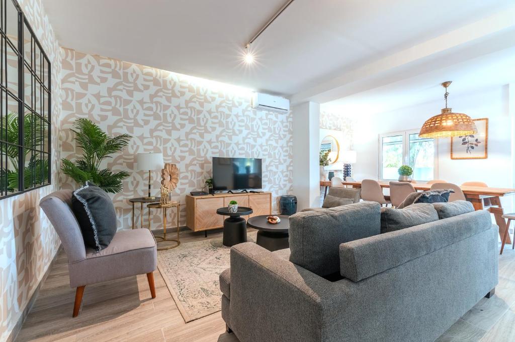 a living room with a couch and a tv at Carregado First Floor in Carregado