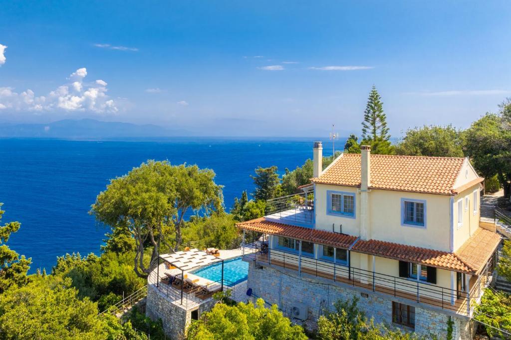 an image of a house with the ocean in the background at Villa Nefeli in Apergátika
