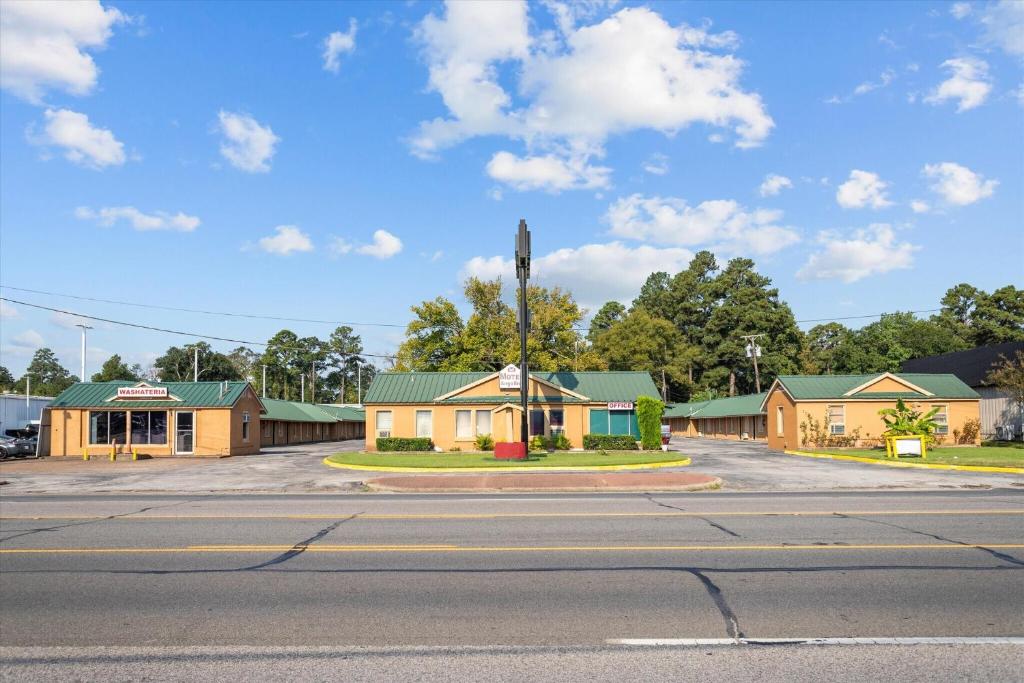 an empty street with a building on the corner at Angelina Motel in Lufkin