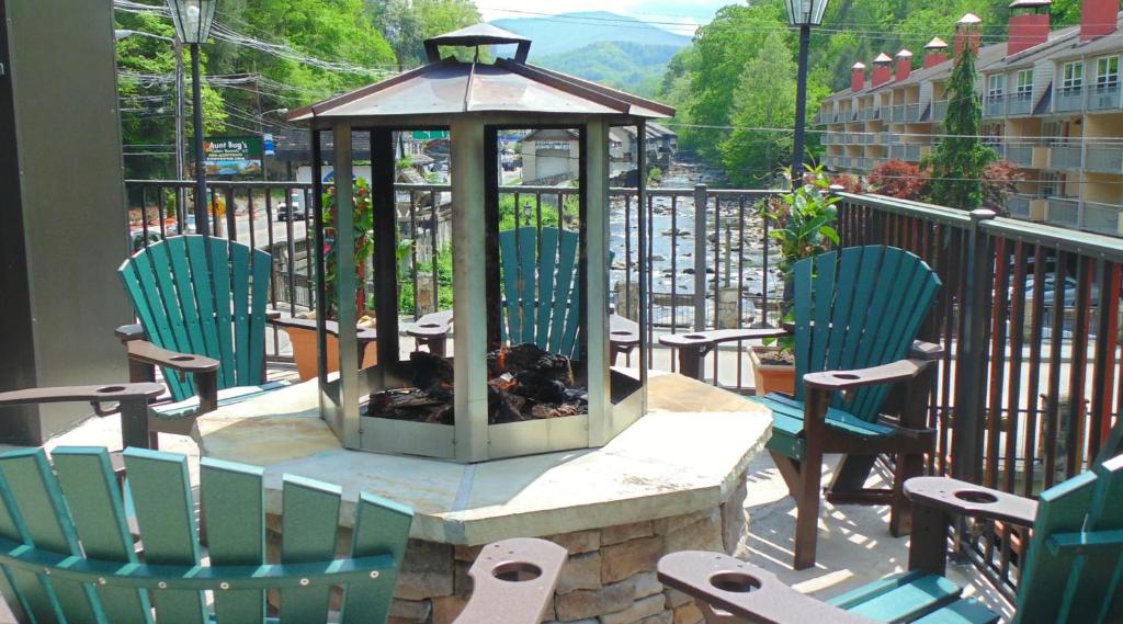 a gazebo with chairs and a fire pit on a balcony at Baymont by Wyndham Gatlinburg On The River in Gatlinburg