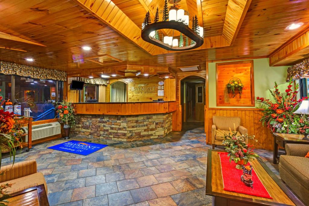 a living room with a fireplace in a house at Baymont by Wyndham Gatlinburg On The River in Gatlinburg