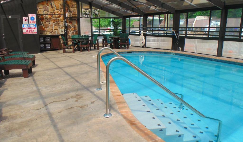 a swimming pool in a building with at Baymont by Wyndham Gatlinburg On The River in Gatlinburg