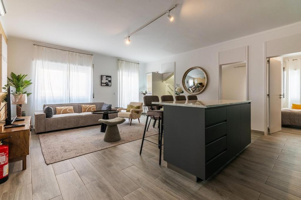 a living room with a kitchen and a living room with a couch at Carregado Second Floor in Carregado