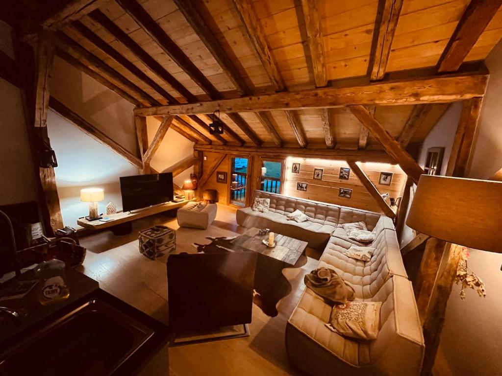an overhead view of a living room with a couch at Chalet Lucien, Jacuzzi, Les 3 Vallées in Villarly